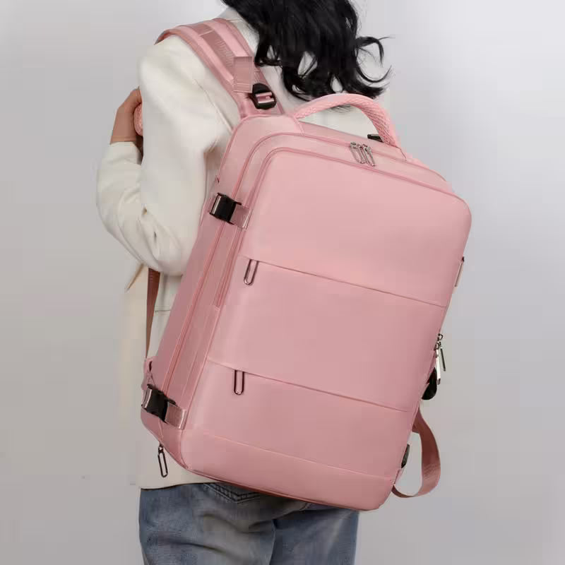 Person wearing a pink backpack on a plain background