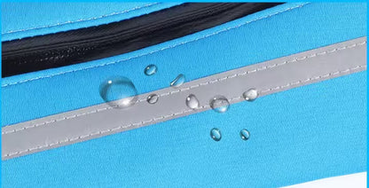 Close-up of a blue fabric with water droplets on a zipper, indicating waterproof material.