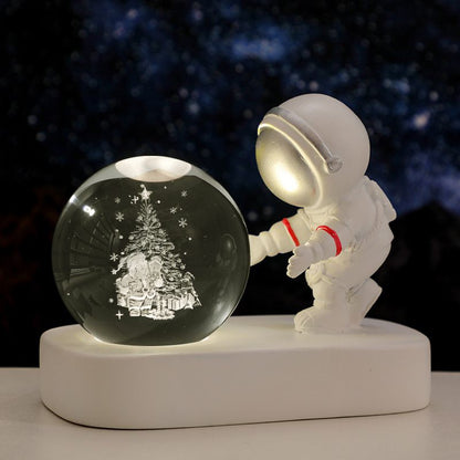 Astronaut figurine interacting with a crystal ball against a starry night sky.