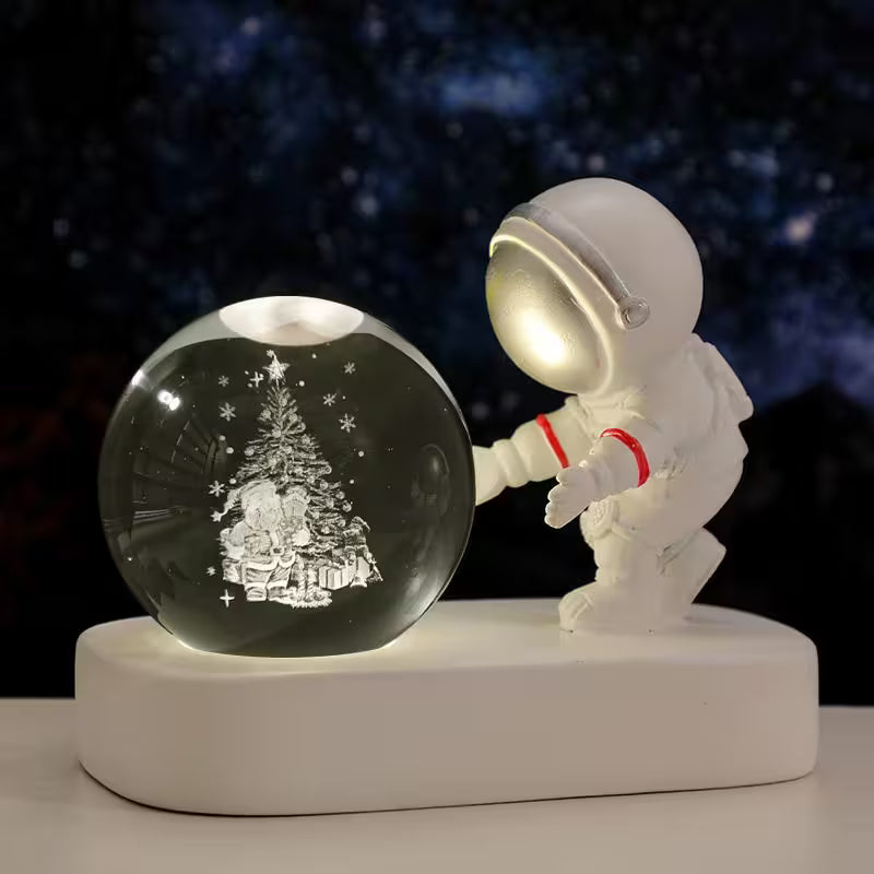 Astronaut figurine interacting with a crystal ball on a dark background