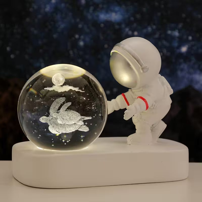 Spaceman figurine interacting with a crystal ball containing a turtle and moon, against a starry night sky.