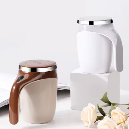 Two ceramic containers with lids on a white surface with flowers.