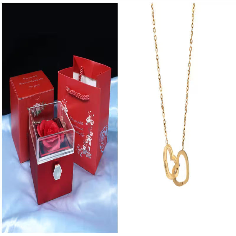 Red gift box with a rose and a gold necklace on a white background