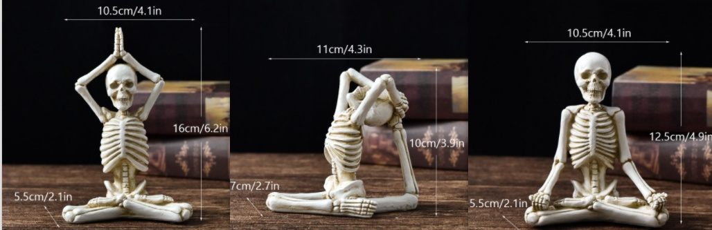 Three skeleton figures in yoga poses with measurements on a wooden surface.