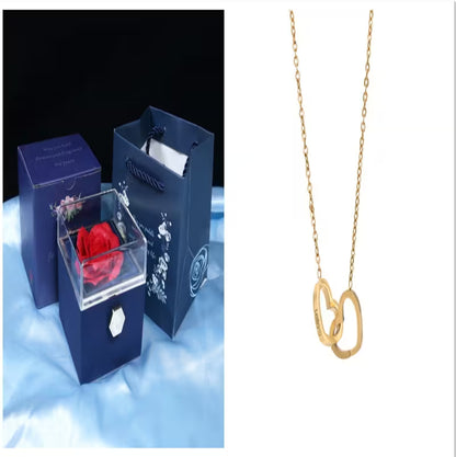Blue gift box with a red rose and gold necklace on a white background
