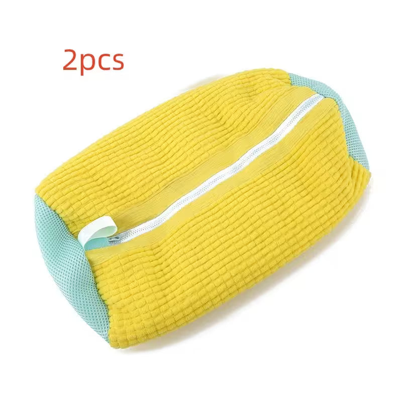 Yellow and teal wedge pillow with a zipper on a white background