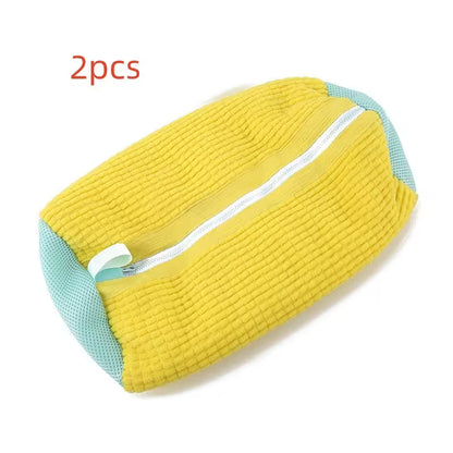 Yellow and teal wedge pillow with a zipper on a white background