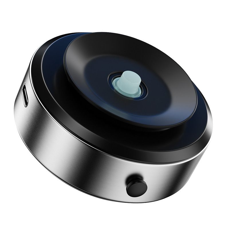 Round electronic device with metallic finish on a white background