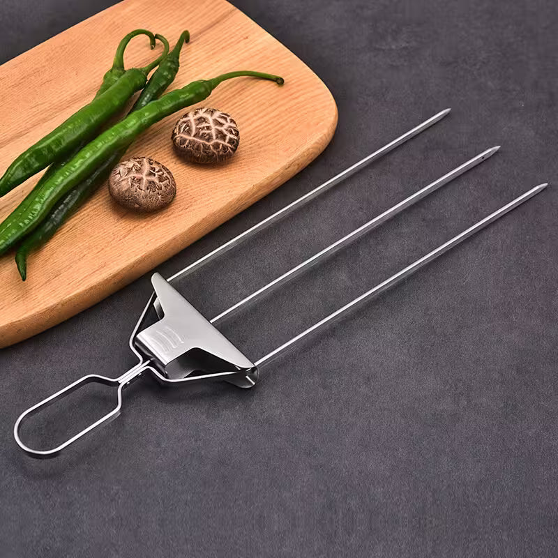 Metal skewer on a dark surface with green peppers and mushrooms on a wooden board.
