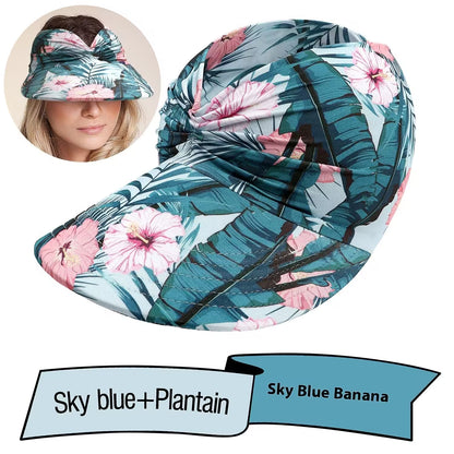 Floral patterned visor hat with a woman wearing it, labeled 'Sky Blue + Plantain'.