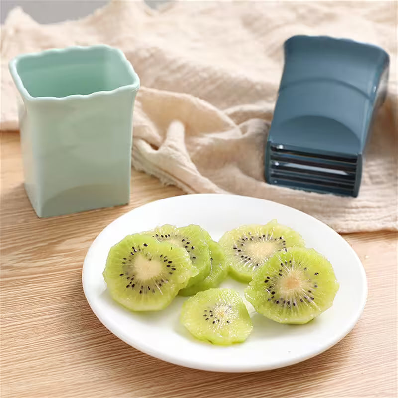 Sliced kiwis on a plate with a kitchen tool in the background