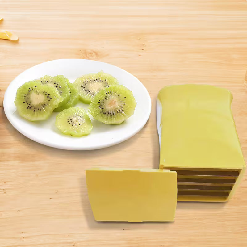 Green fruit slicer with sliced kiwis on a wooden surface