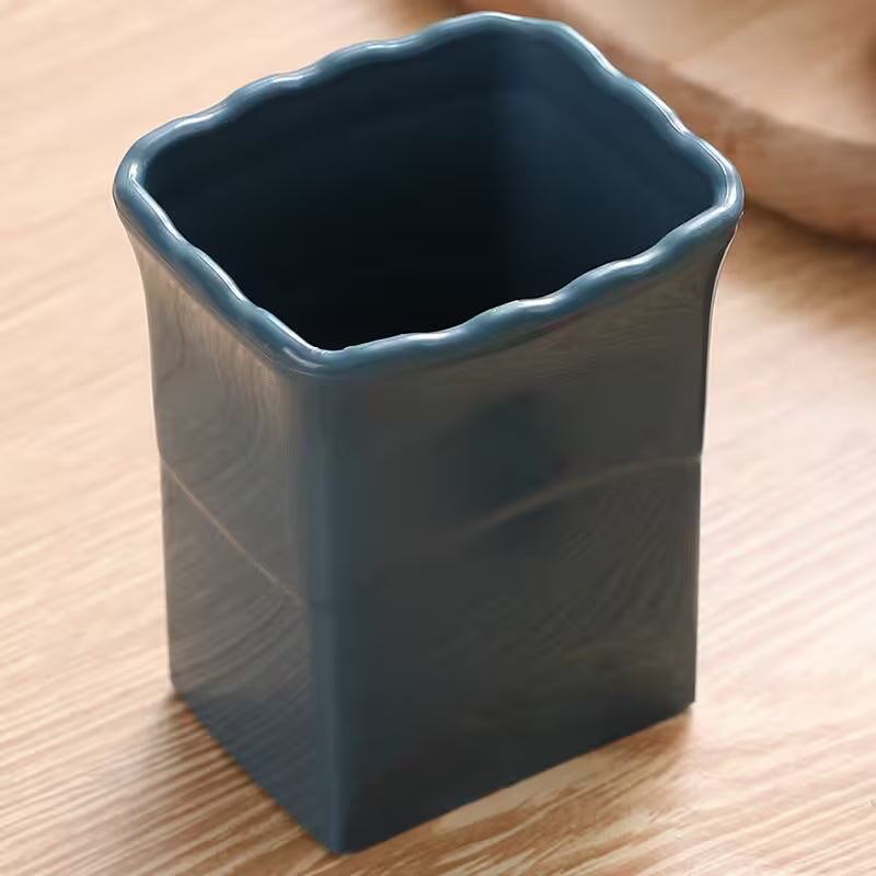 Blue ceramic vase on a wooden surface