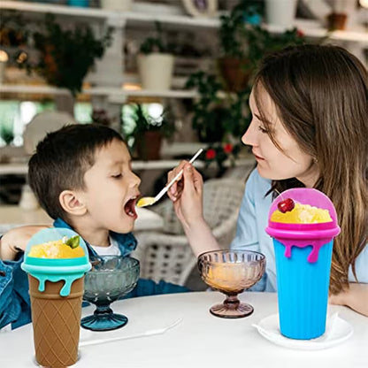 Woman feeding a child with a spoon, both using colorful ice cream-themed cups.