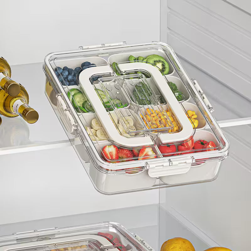 Clear food storage container with compartments filled with various fruits and vegetables inside a refrigerator.