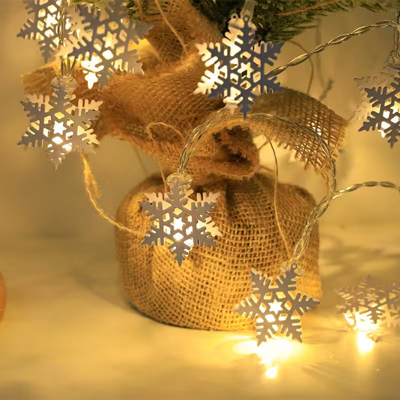Decorative setup with burlap sack, snowflake lights, and string lights on a soft focus background