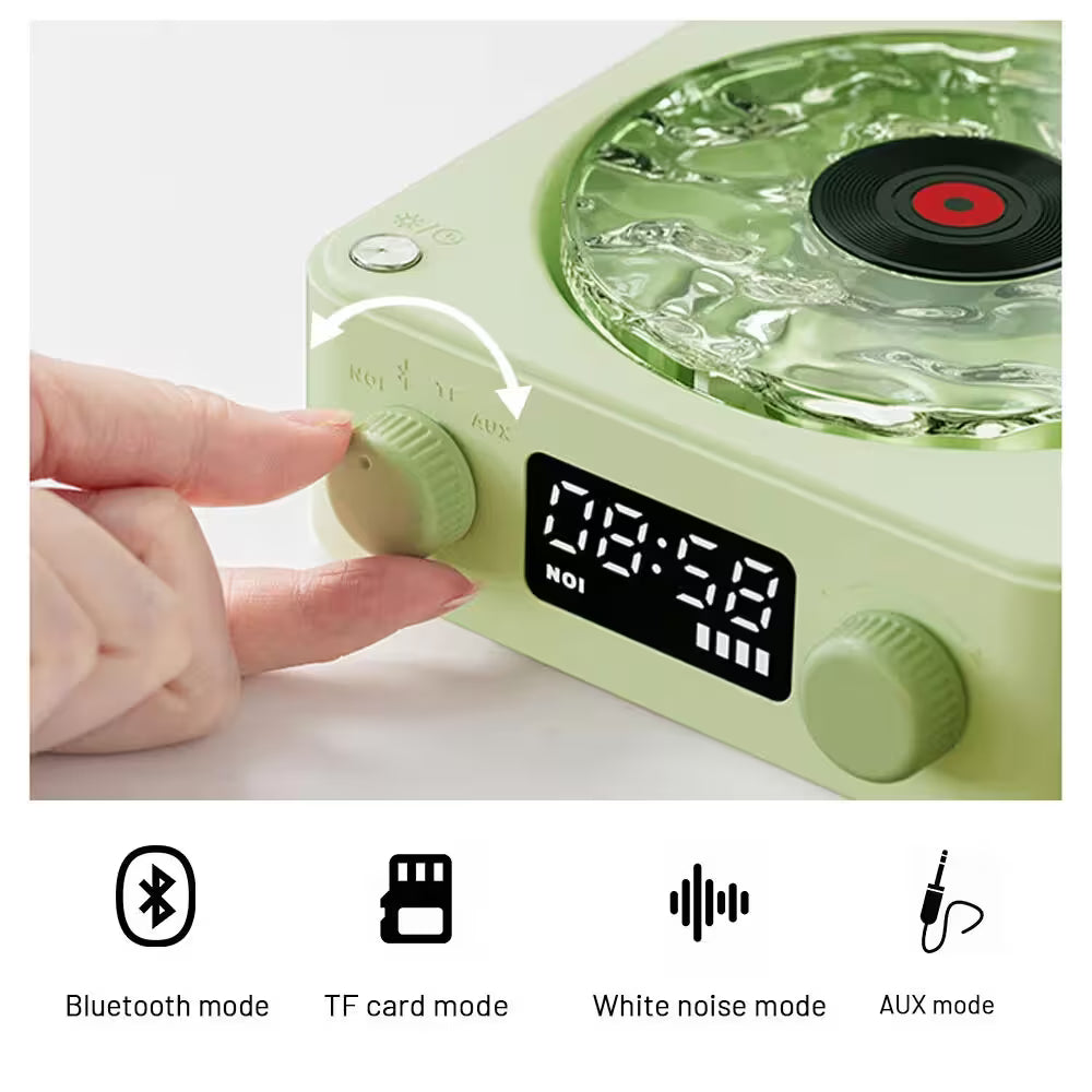 Green electronic device with a digital display and control knobs, featuring Bluetooth, TF card, white noise, and AUX mode icons.