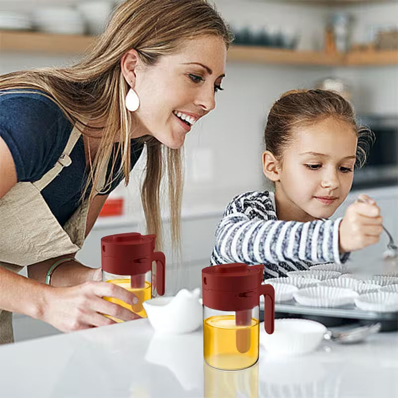Woman and child in a kitchen with a red and yellow container
