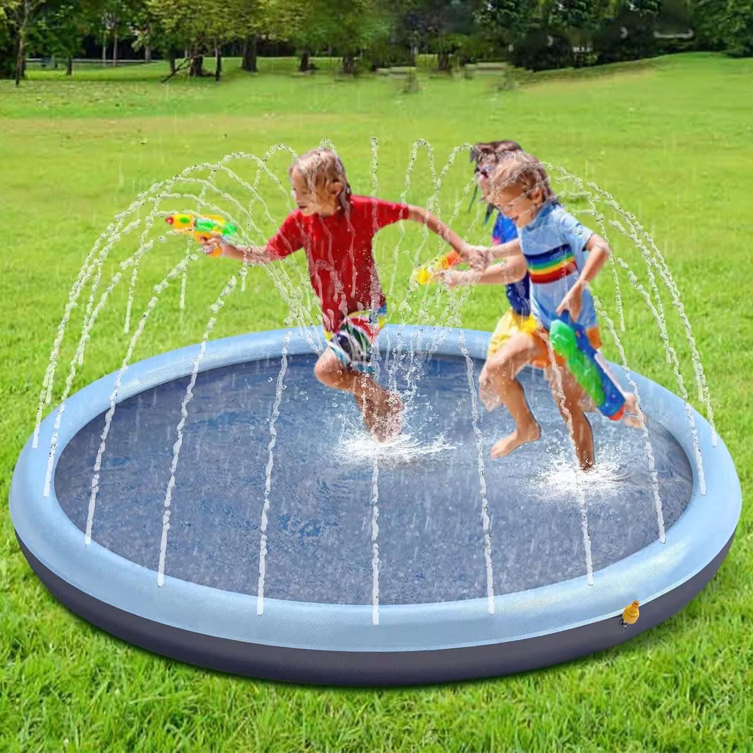 Two children playing in a inflatable water sprinkler pad on a grassy field.