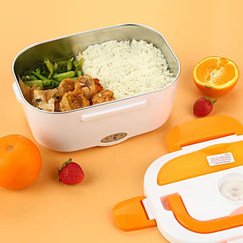 Stainless steel inner container of electric lunch box open with hot rice chicken and vegetables — portable cordless food heater heating home-cooked meal for office workers