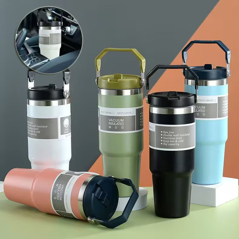 Collection of vacuum insulated mugs in various colors on a colorful background