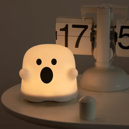 Ghost-shaped night light on a dark background