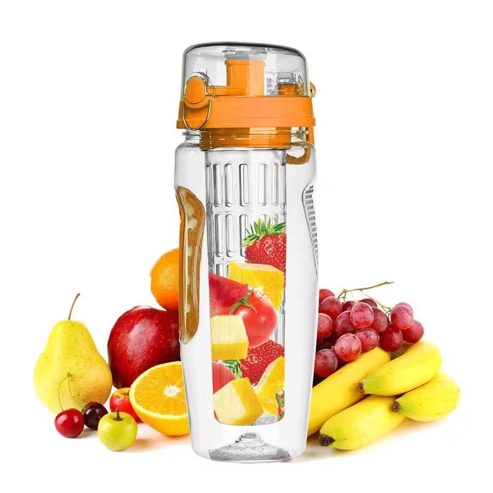 Clear water bottle with orange top surrounded by fruits on a white background