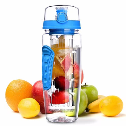 Clear water bottle with blue lid and handle, filled with fruits, surrounded by additional fruits on a white background.