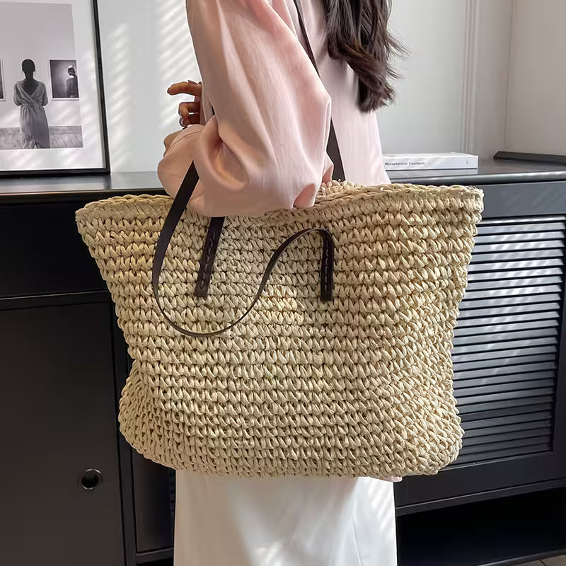 Person holding a woven straw bag indoors