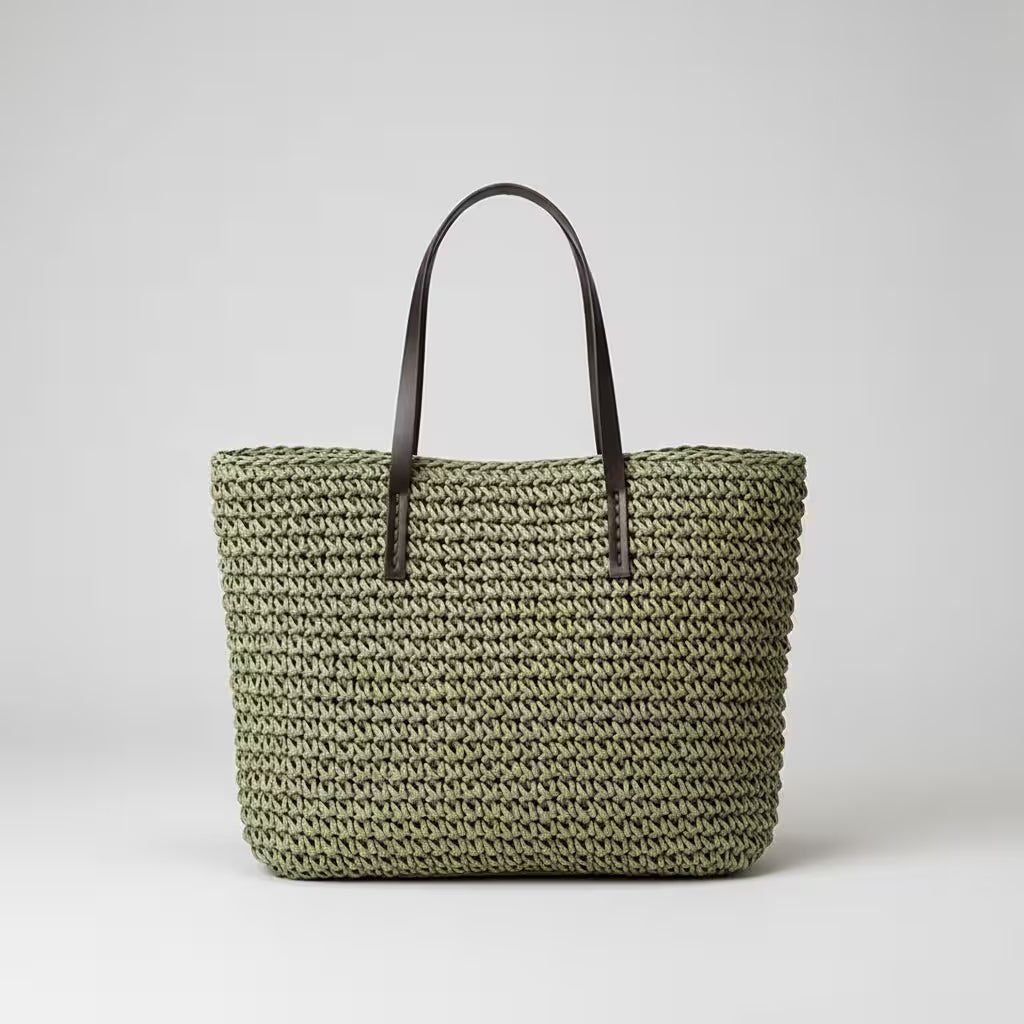 Woven handbag with brown handles on a light gray background