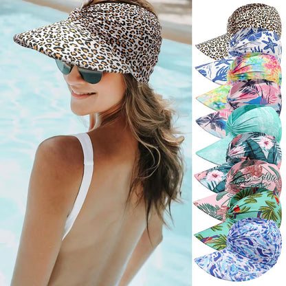 Woman wearing a leopard print visor with a pool in the background, surrounded by various colorful visors.