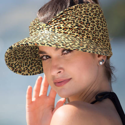 Woman wearing a leopard print visor hat with a blurred background