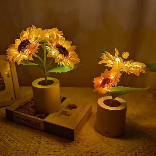 Decorative sunflower lights in small pots on a textured surface with a blurred background