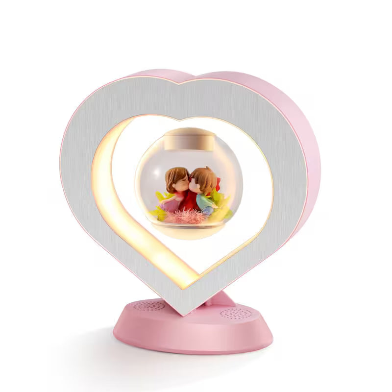 Heart-shaped lamp with a decorative ball featuring two people on a white background