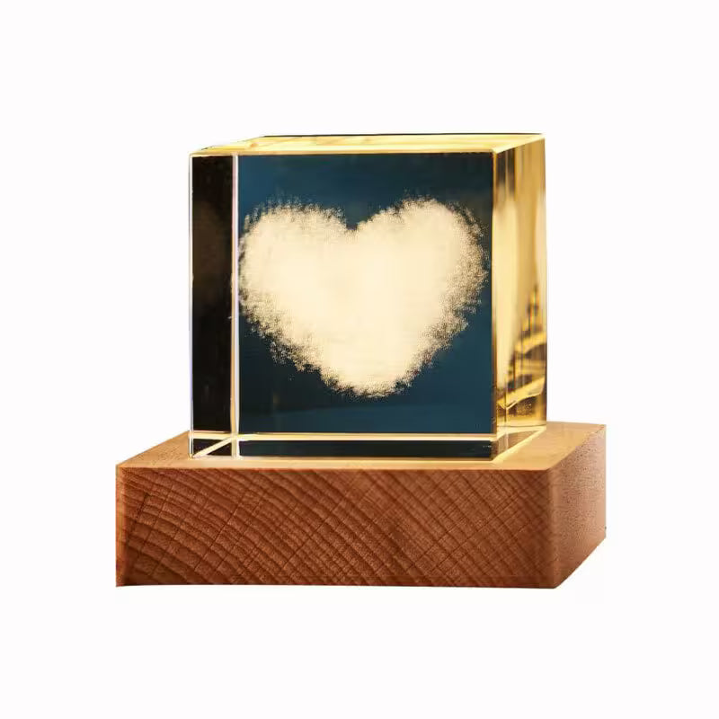 Decorative object with a heart-shaped light inside a gold frame on a wooden base