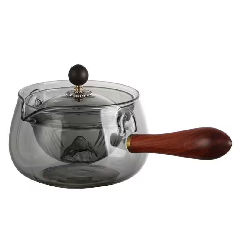Clear glass teapot with wooden handle and lid knob on a white background