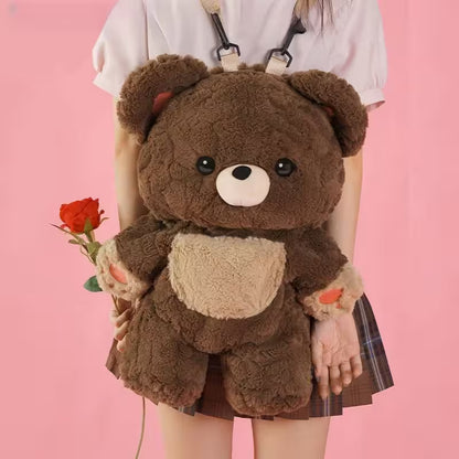 Person wearing a large brown teddy bear-shaped backpack on a pink background