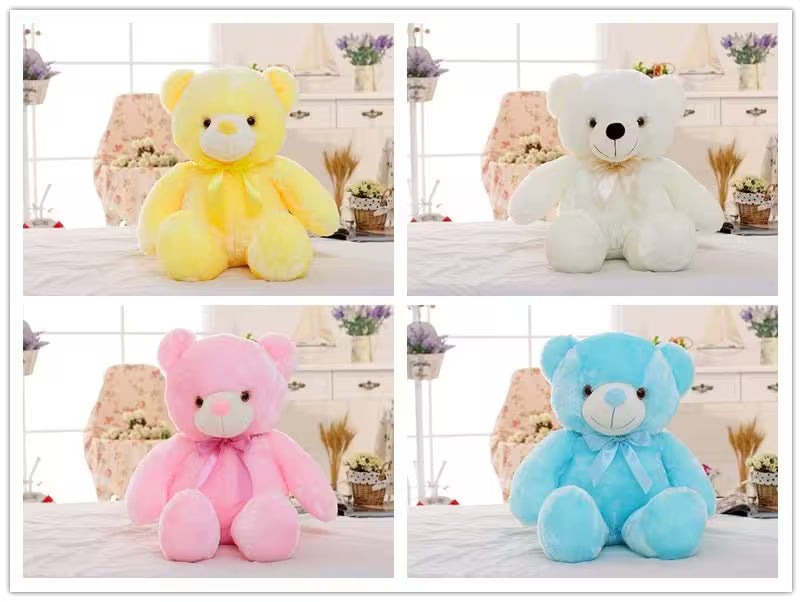 Four teddy bears in yellow, white, pink, and blue on a decorative background.