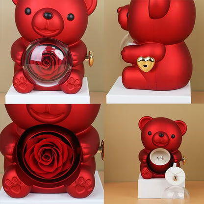 Red teddy bear with a glass ball containing a rose, heart-shaped padlock, and ring inside.