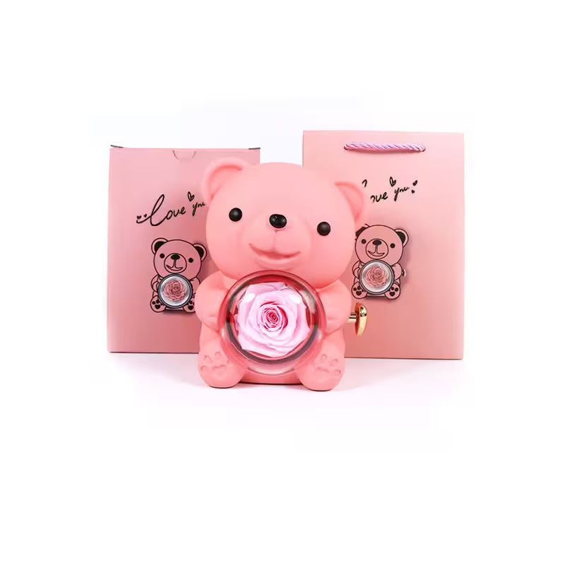 Pink teddy bear-shaped container with a rose inside, set against a white background