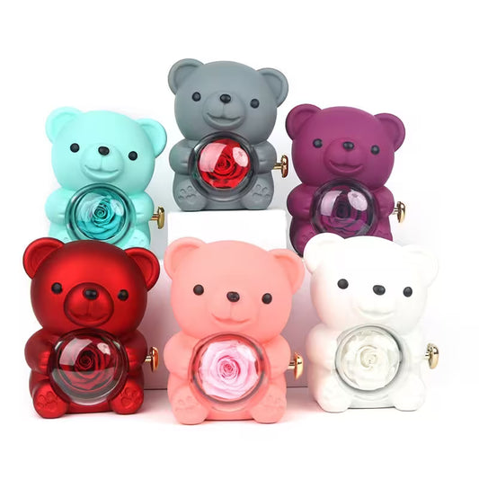 Colorful teddy bear-shaped objects with rose designs on a white background