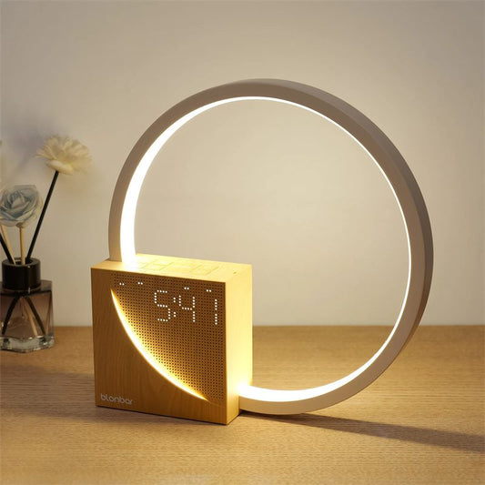 Modern table lamp with digital clock display on a wooden surface