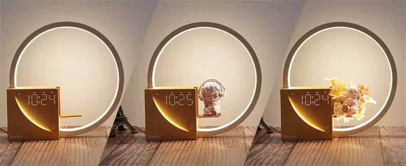 Three decorative items with digital displays on a wooden surface, framed by circular light panels.