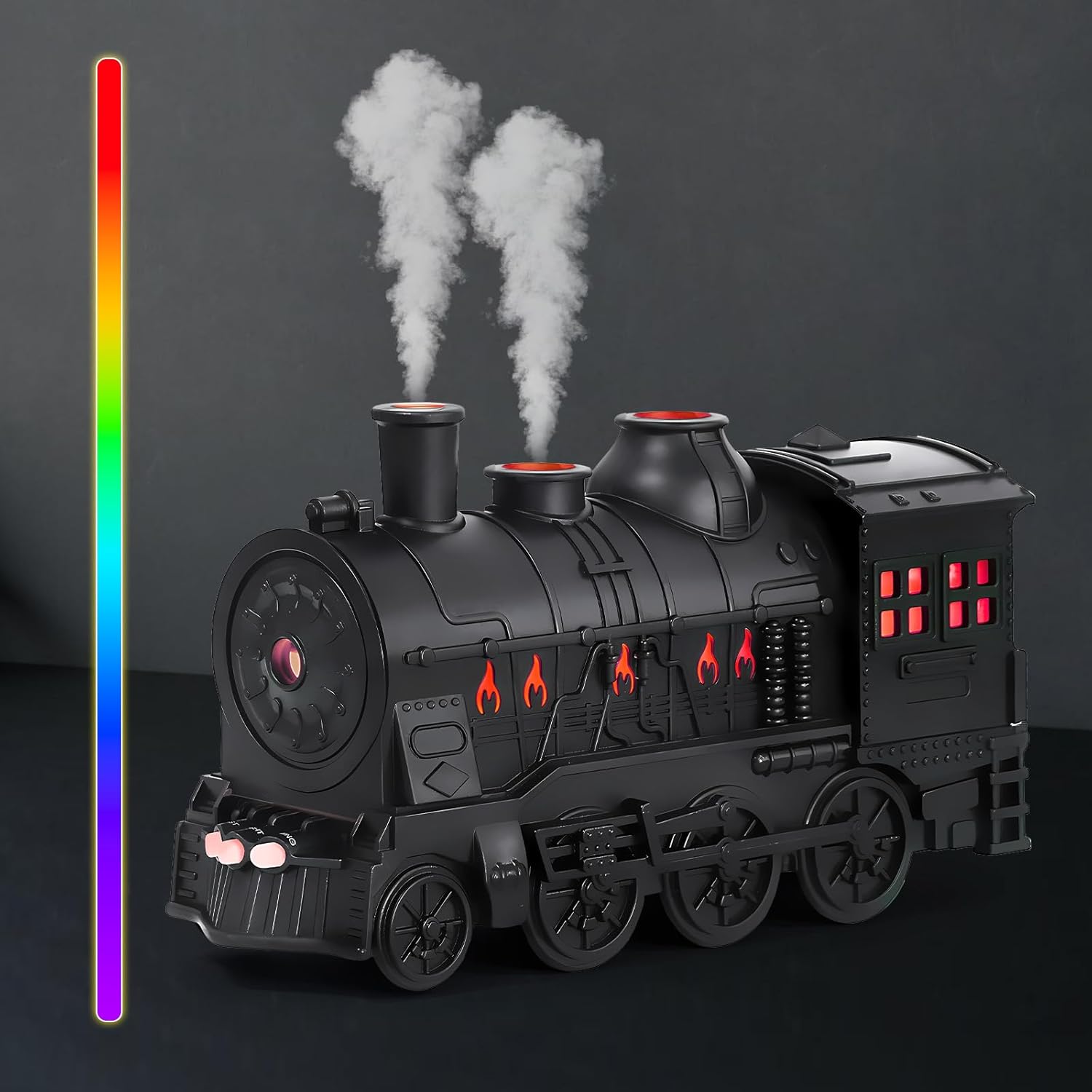 Black toy steam train with smoke on a dark background