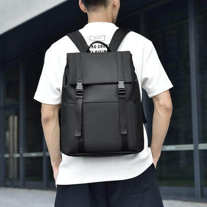 Person wearing a black backpack in an urban setting