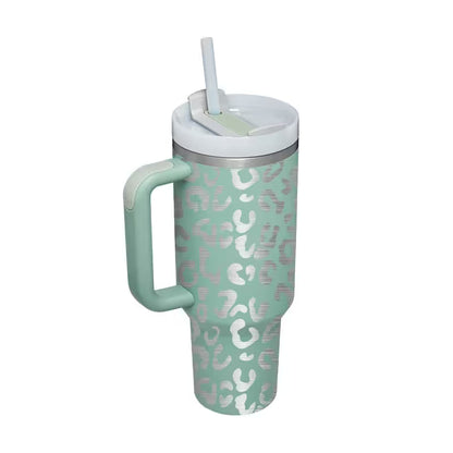 Mint green tumbler with pink leopard print pattern on a white background