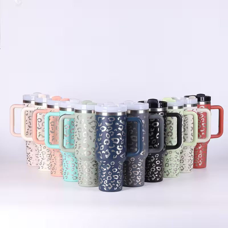 Set of insulated travel mugs with various patterns and colors on a white background