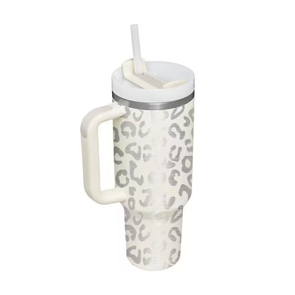 Leopard print tumbler with a handle and straw on a white background