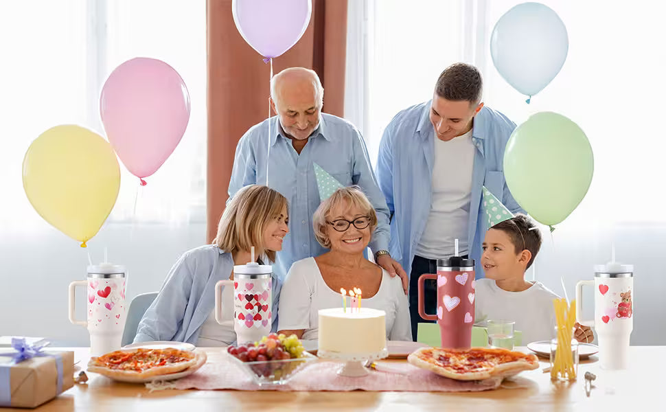 Family celebrating a birthday with balloons and cake