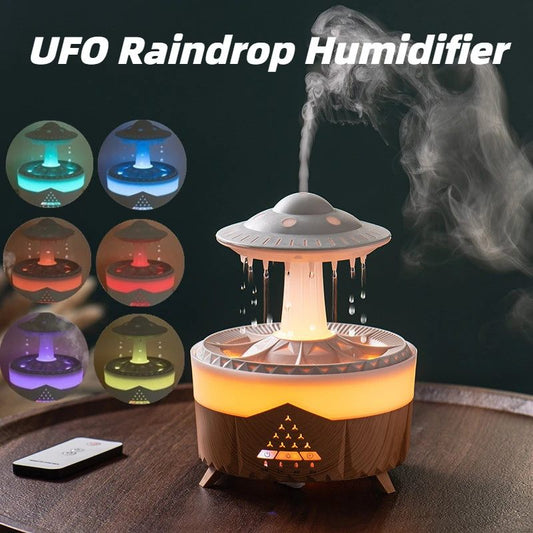 UFO raindrop humidifier with colorful light display and steam rising, on a dark background.